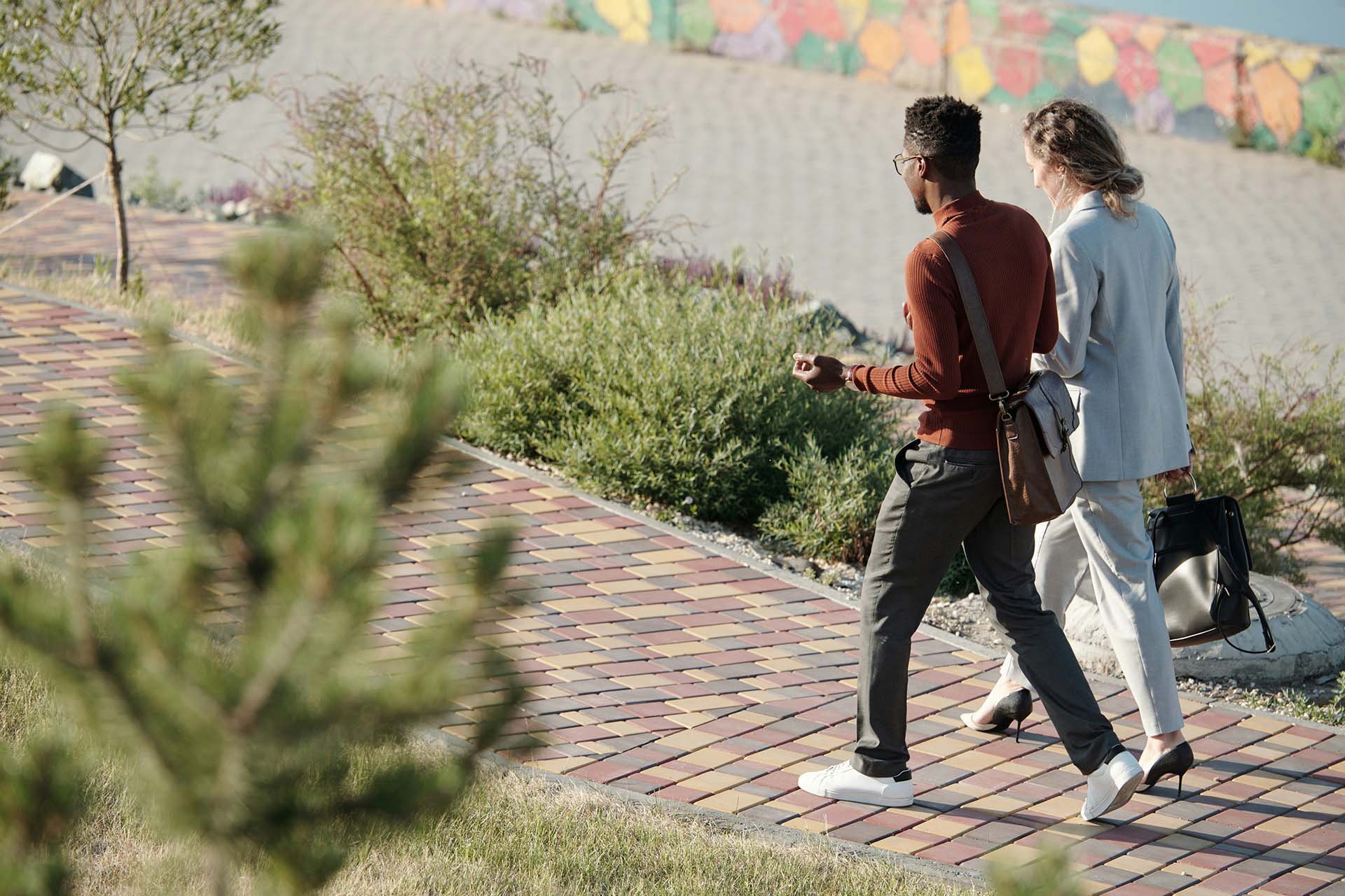 Couple walking on paved sidewalk