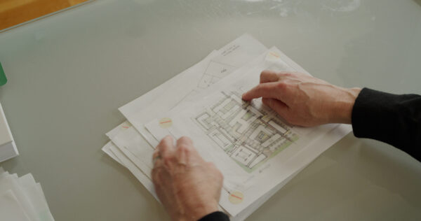 Architect reviewing scale drawings of Utah City.